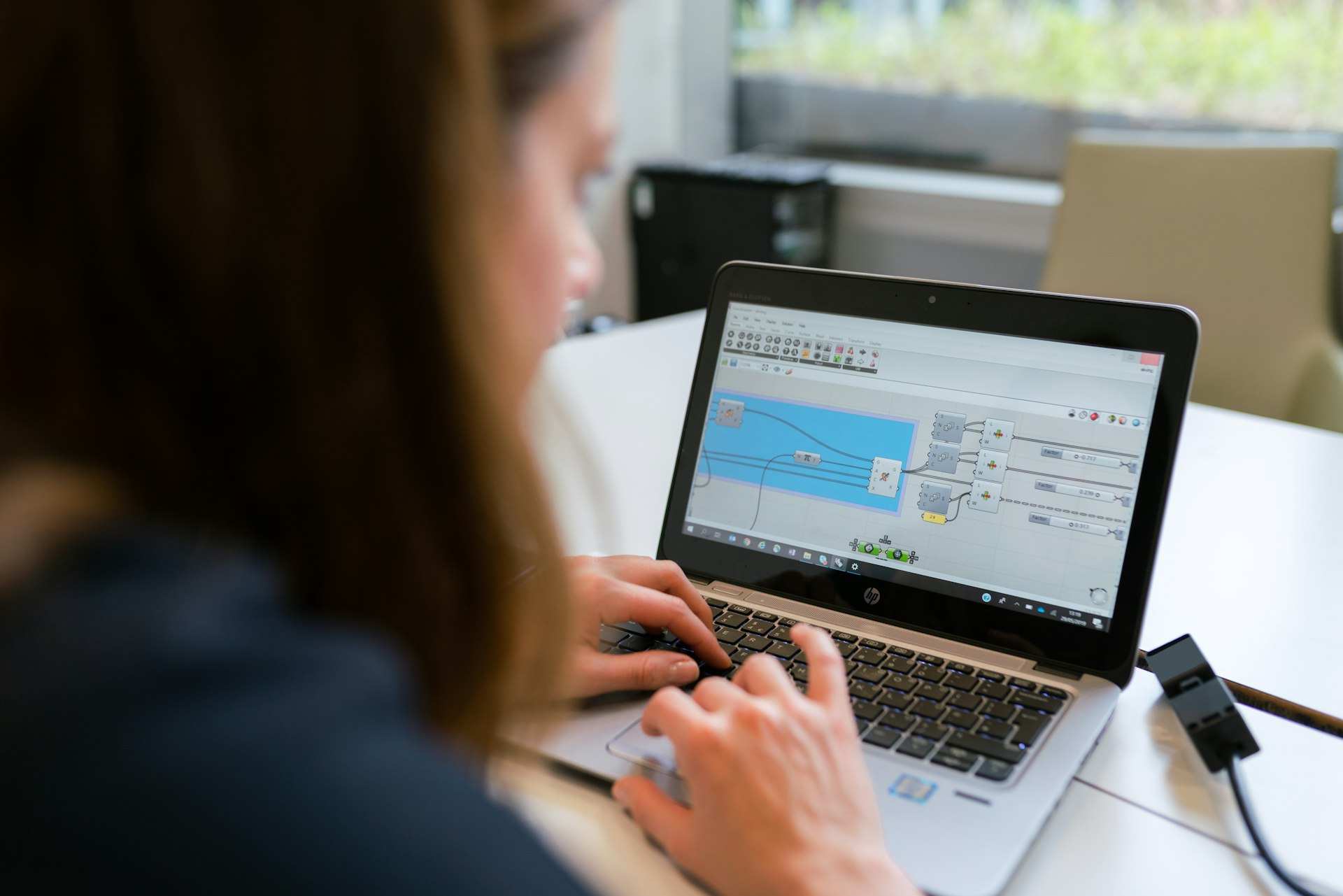 woman in black long sleeve shirt using macbook pro